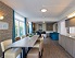Gruppenhotel Oase, Frühstückszimmer mit Sitzecke und Fernseher